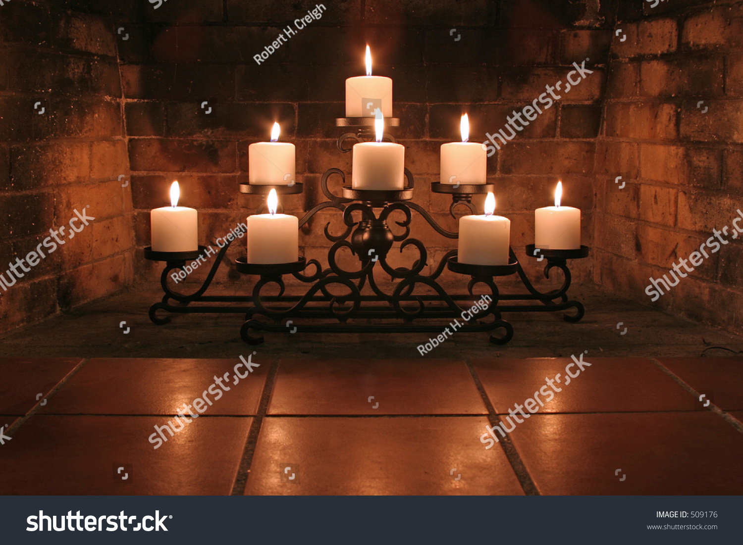 Fireplace Candelabra With 8 Candles Projecting Nice Glow On Bricks In