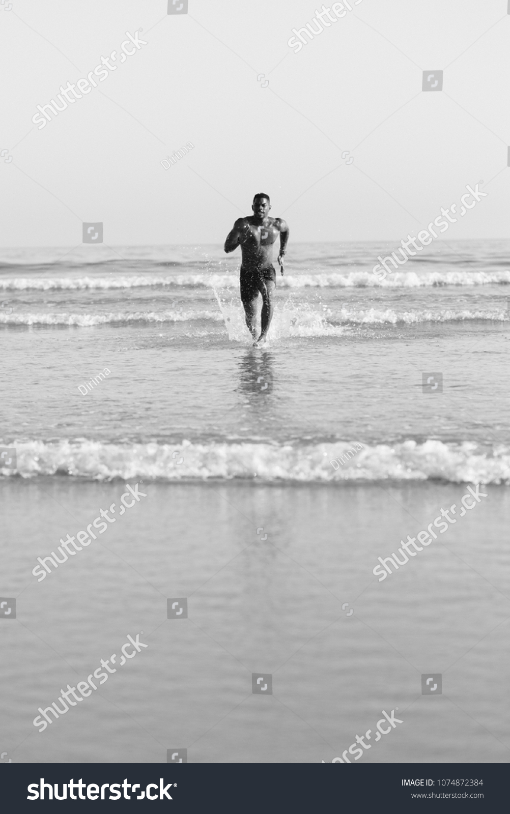 Fit Black Man Running Seaside Splashing Stock Photo