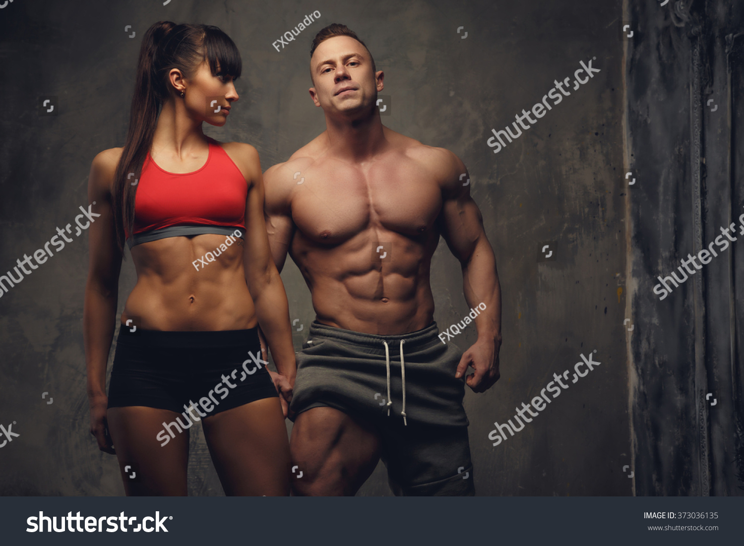 Fitness Couple Shirtless Bodybuilder And Fitness Woman In Sportswear