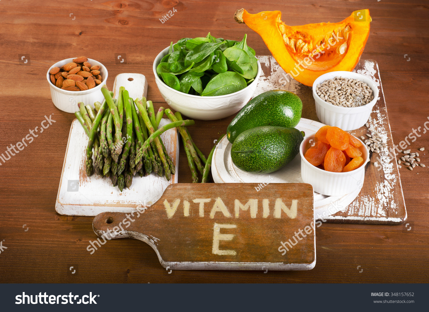 foods-containing-vitamin-e-on-a-wooden-board-view-from-above-stock-photo-348157652-shutterstock