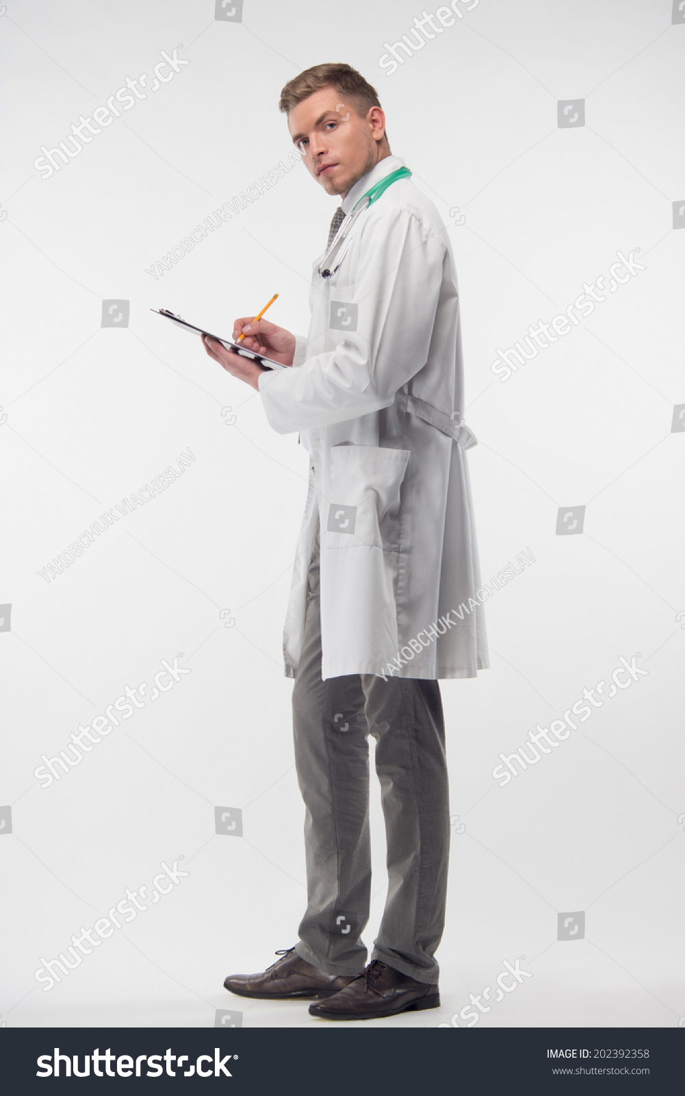 Full Length Portrait Of Very Attractive Doctor Wearing White Coat