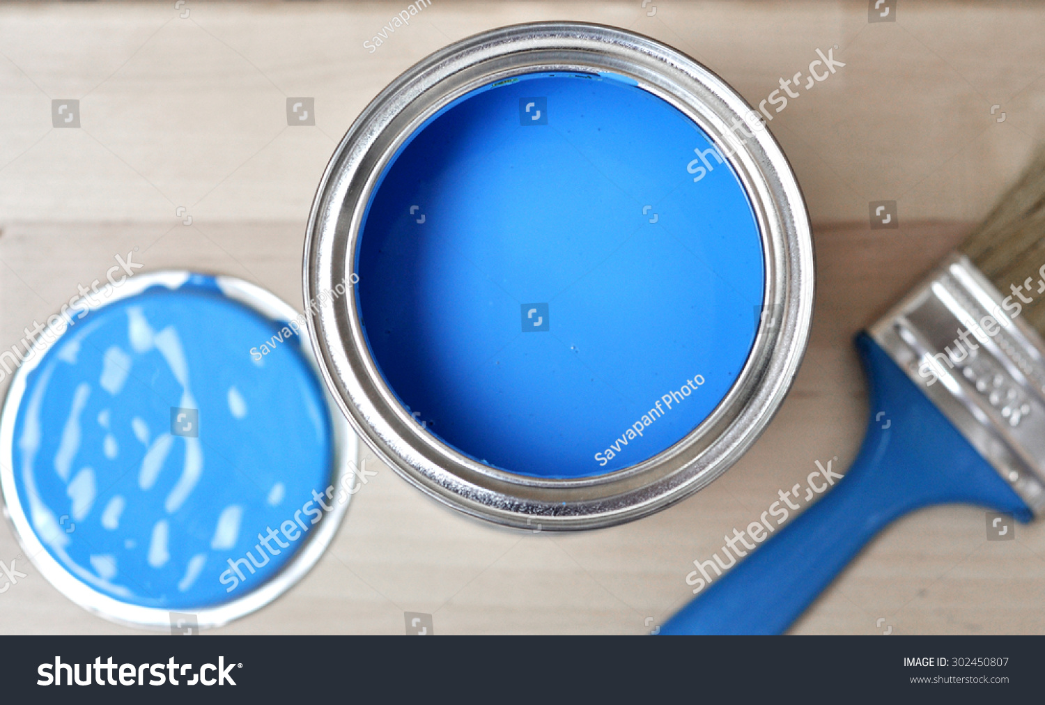 Full of blue paint tin and paint brush Full of blue paint tin and paint brush