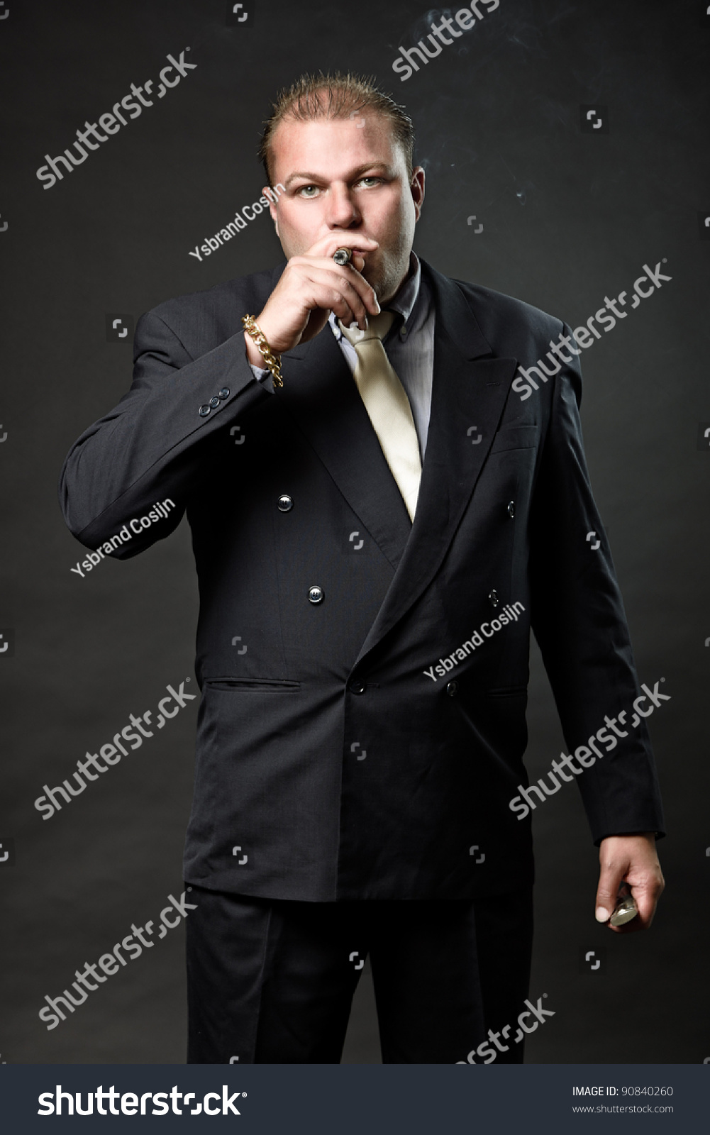 Gangster Mafia Man In Suit With Tie Looking Tough Isolated On Dark