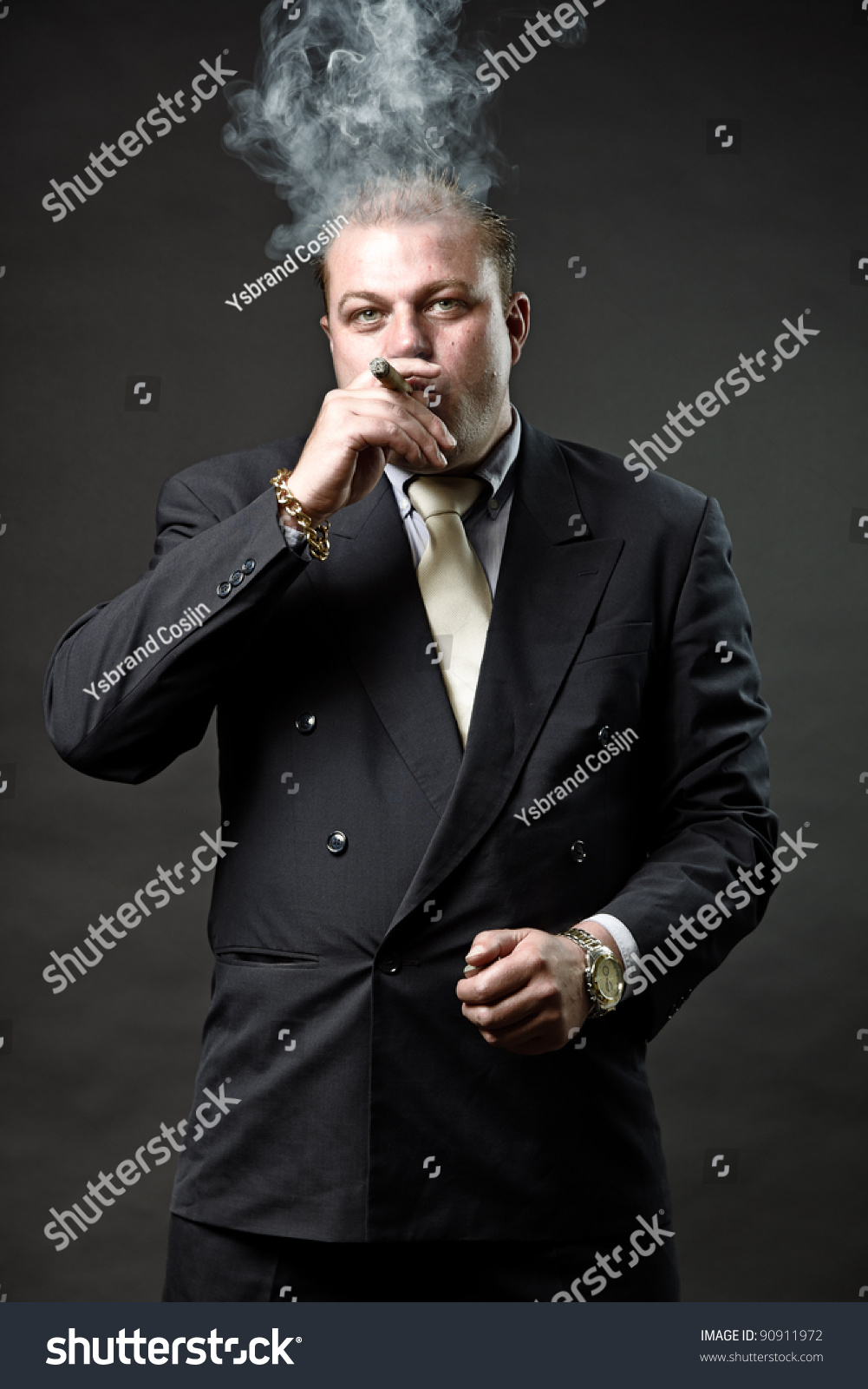 Gangster Mafia Man In Suit With Tie Looking Tough Isolated On Dark