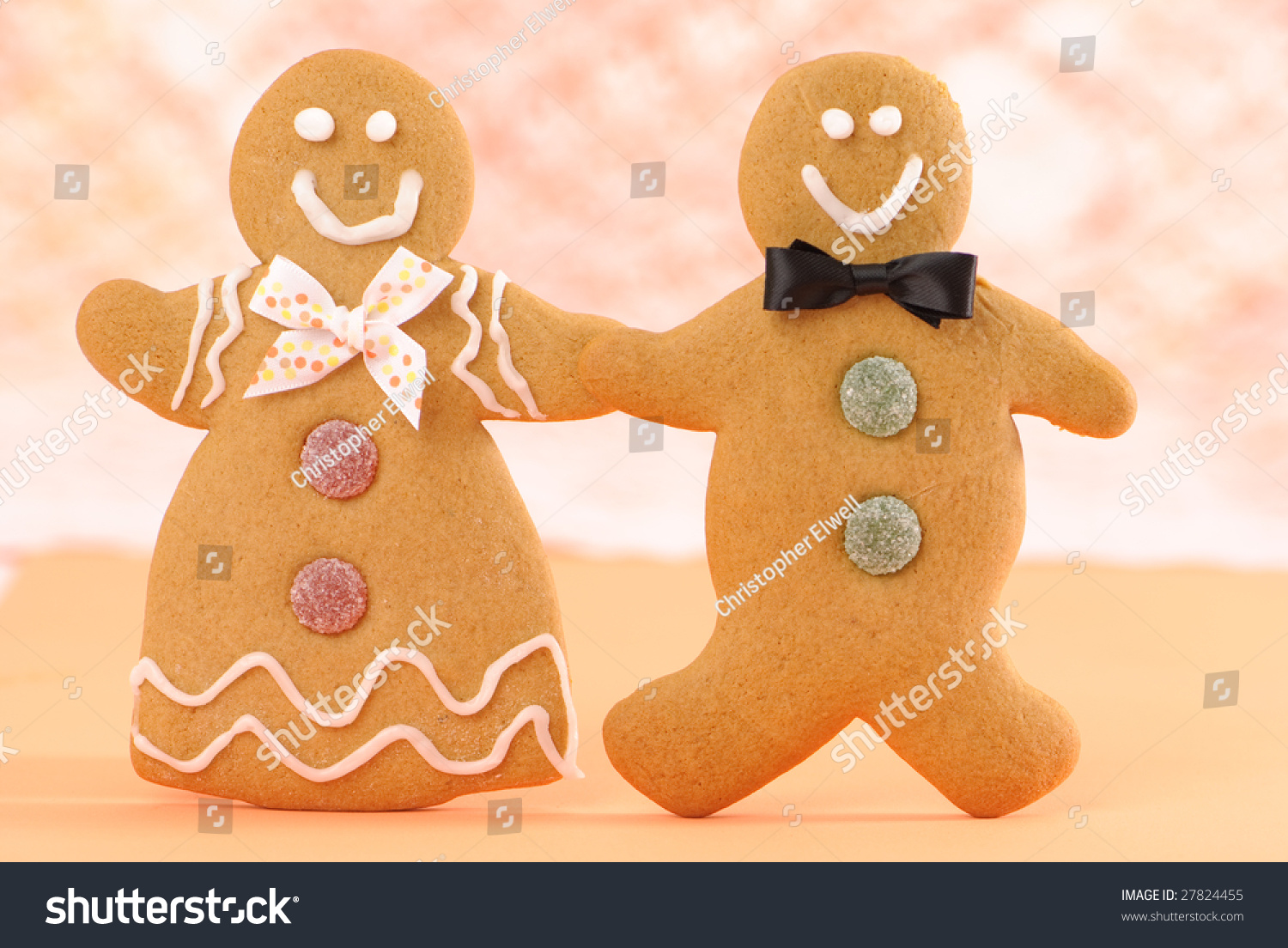 Gingerbread Man And Woman Holding Hands In Orange Setting Stock Photo 