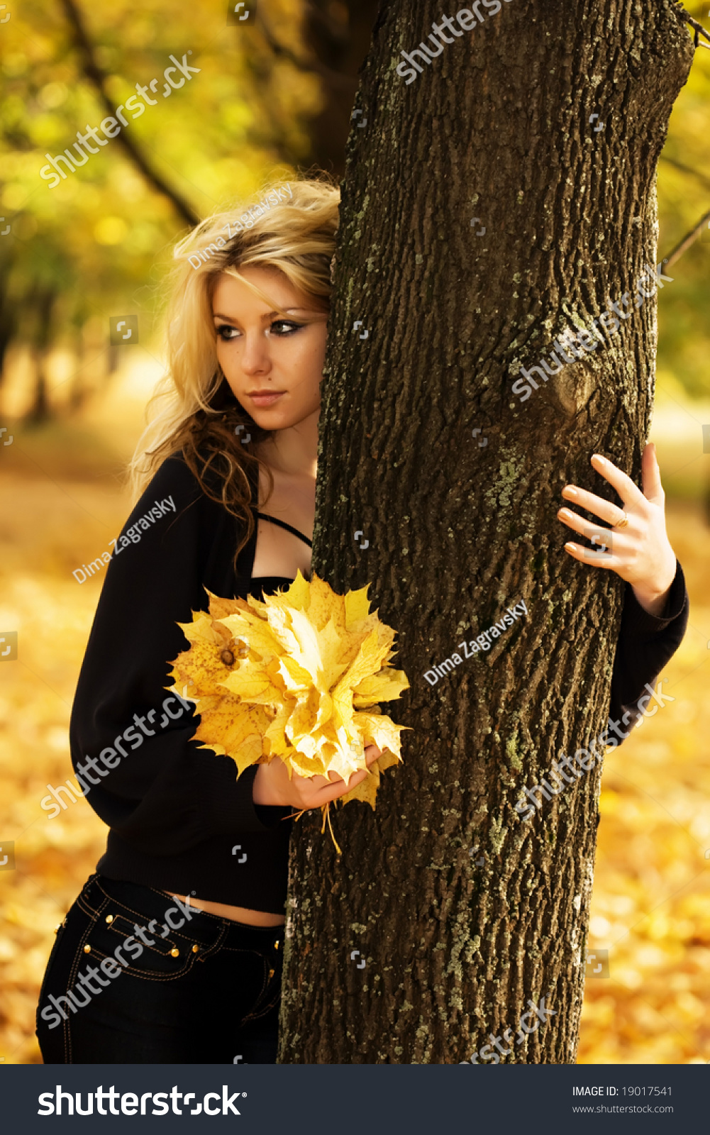 Girl With Leaves In Her Hand Behind A Tree Stock Photo 19017541 