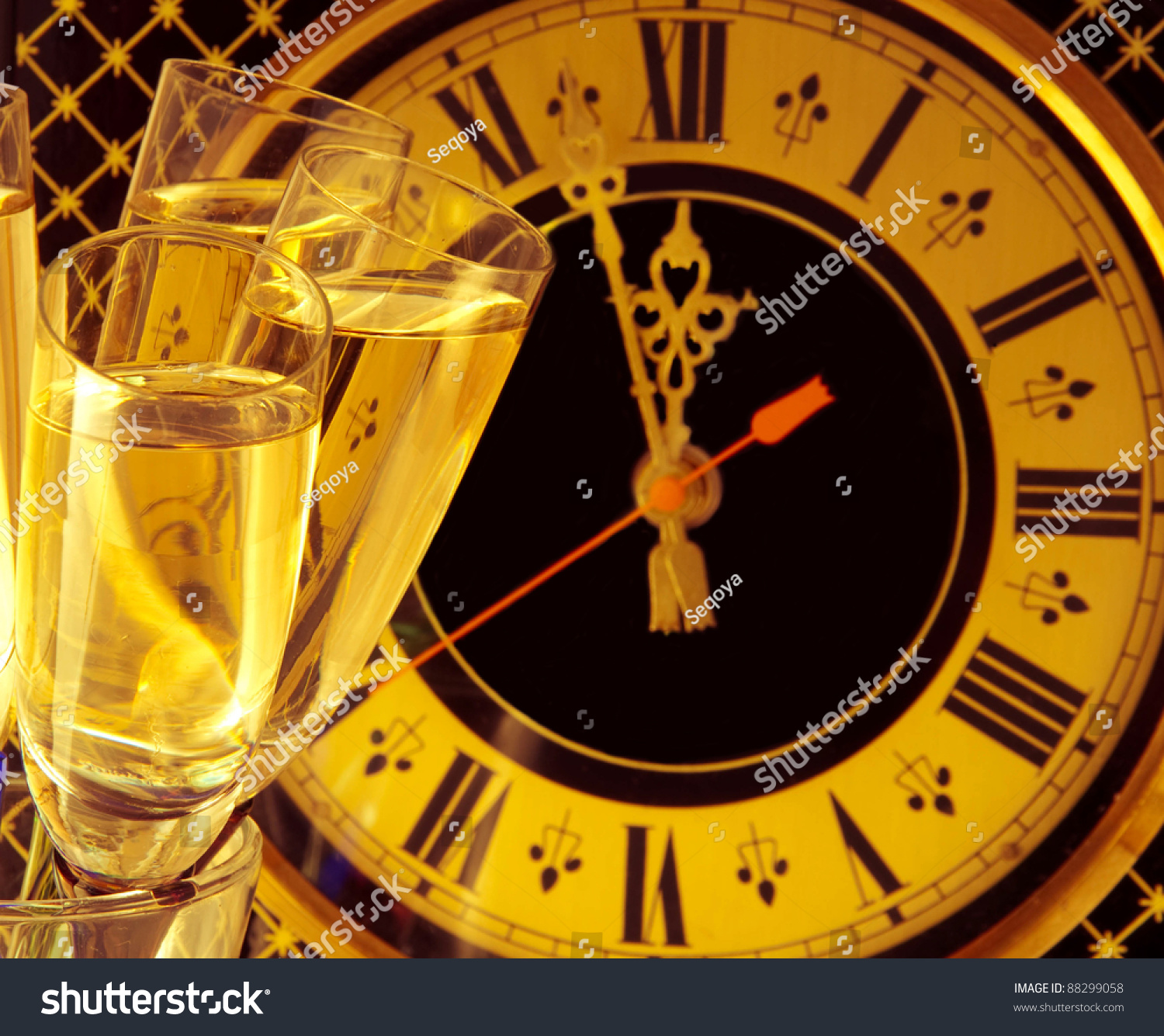 Glasses Of Champagne On New Year&#039;S Eve Against An Ancient Wall Clock Stock Photo 88299058