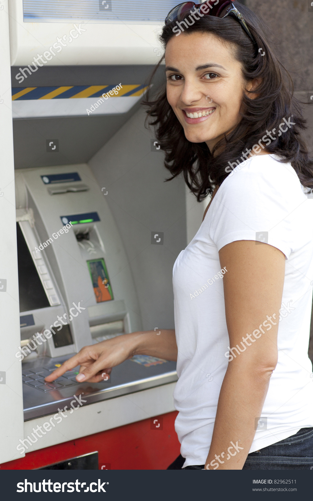 http://image.shutterstock.com/z/stock-photo-good-looking-latin-woman-enters-the-pin-number-at-the-atm-82962511.jpg