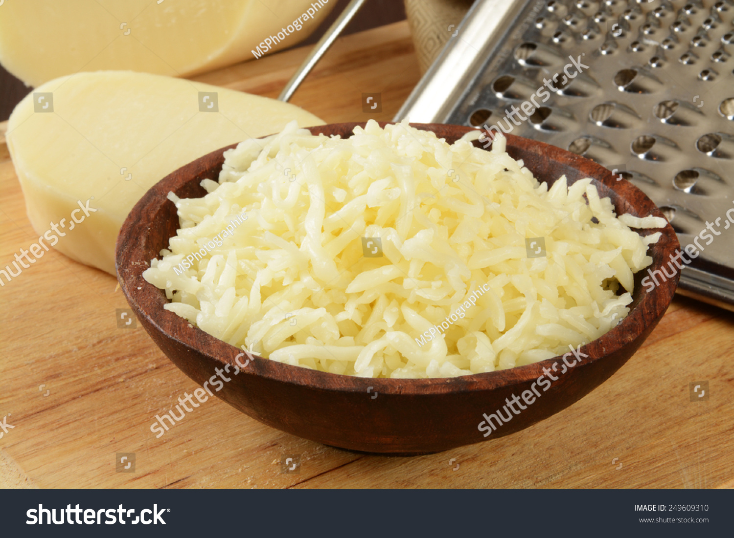 Grated mozzarella cheese in a wooden bowl