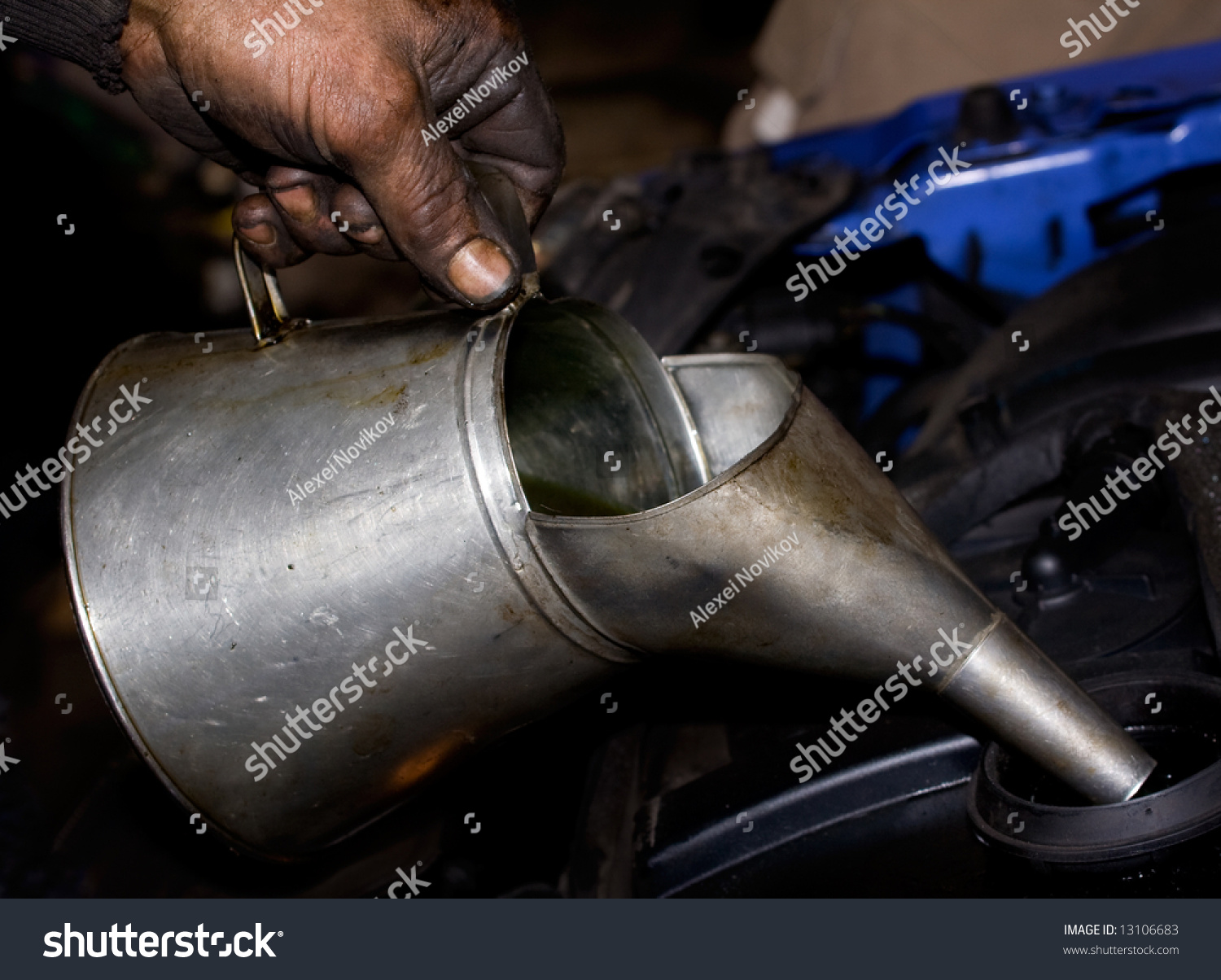 Greasy Hand Pouring Motor Oil Into A Car Engine Stock Photo 13106683