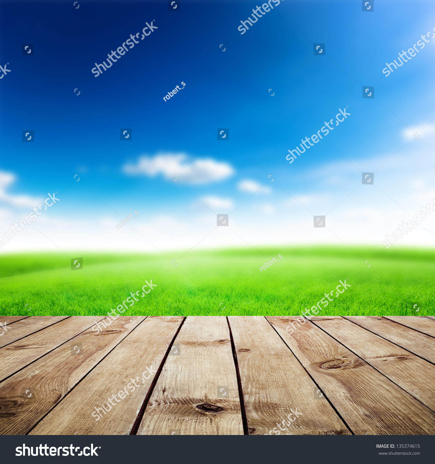 Green Field Under Blue Sky. Wood Planks Floor. Beauty Nature Background 