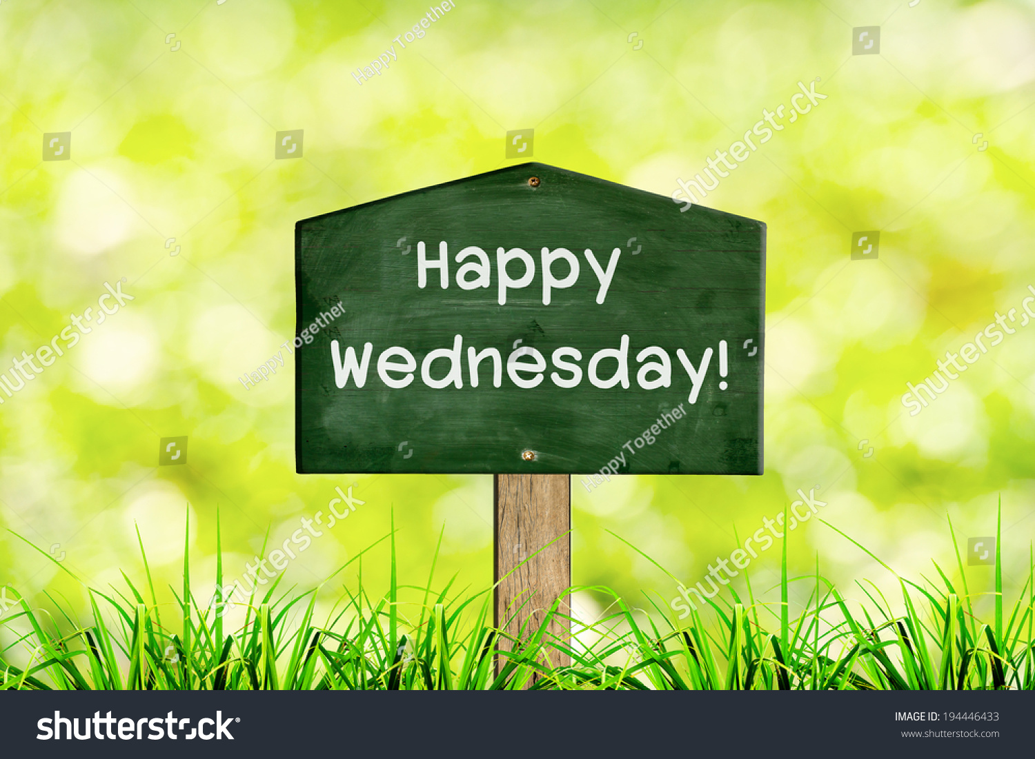 Green Sign Board With Natural Background And Message Happy Wednesday