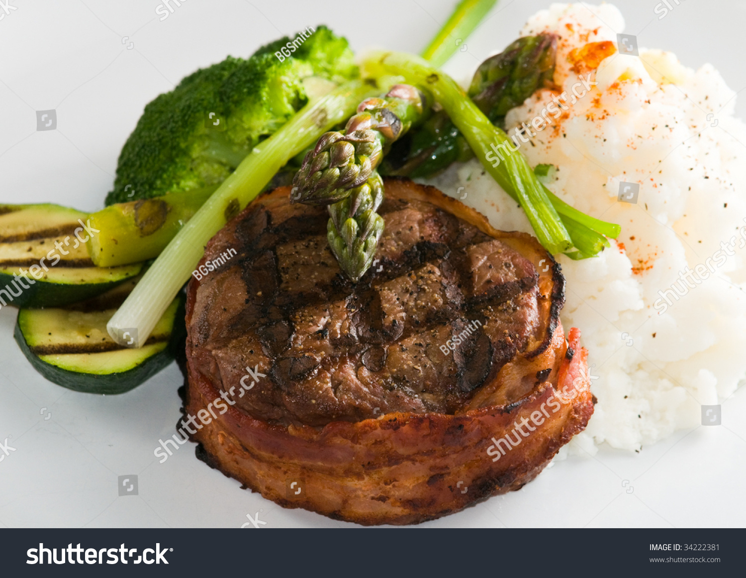 Grilled Steak Wrapped In Bacon, With Grilled Vegetables, Mashed Potatoes, Garlic Toast, And