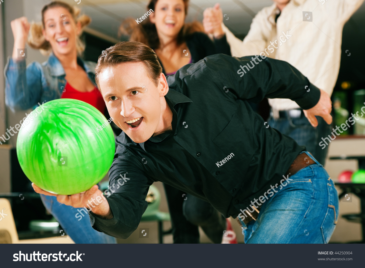 Three Friends Laughing In Bowling Alley Of Four Friends In A Bowling Alley Three