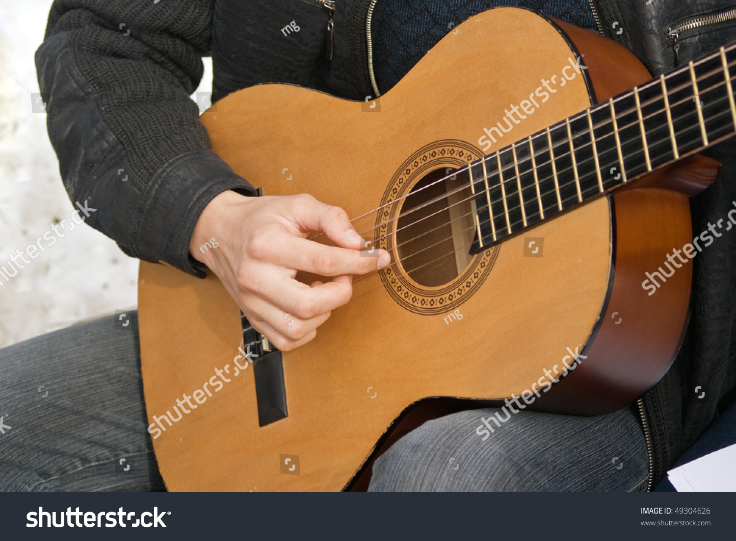 guitarist playing in picnic against snow guitarist playing in picnic against snow