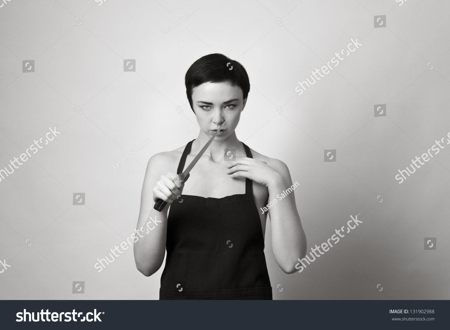 Half Naked Woman Holding A Knife And Just Wearing A Apron Stock Photo