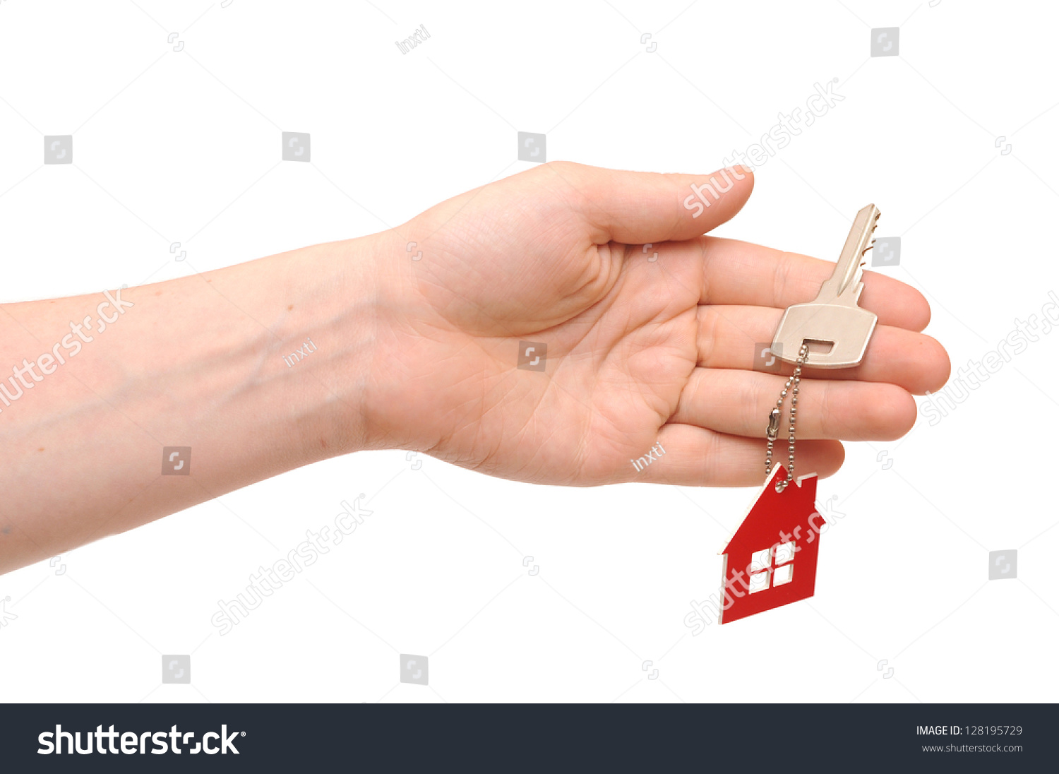 Hand Holding Key With A Key-chain In The Shape Of The House On The 