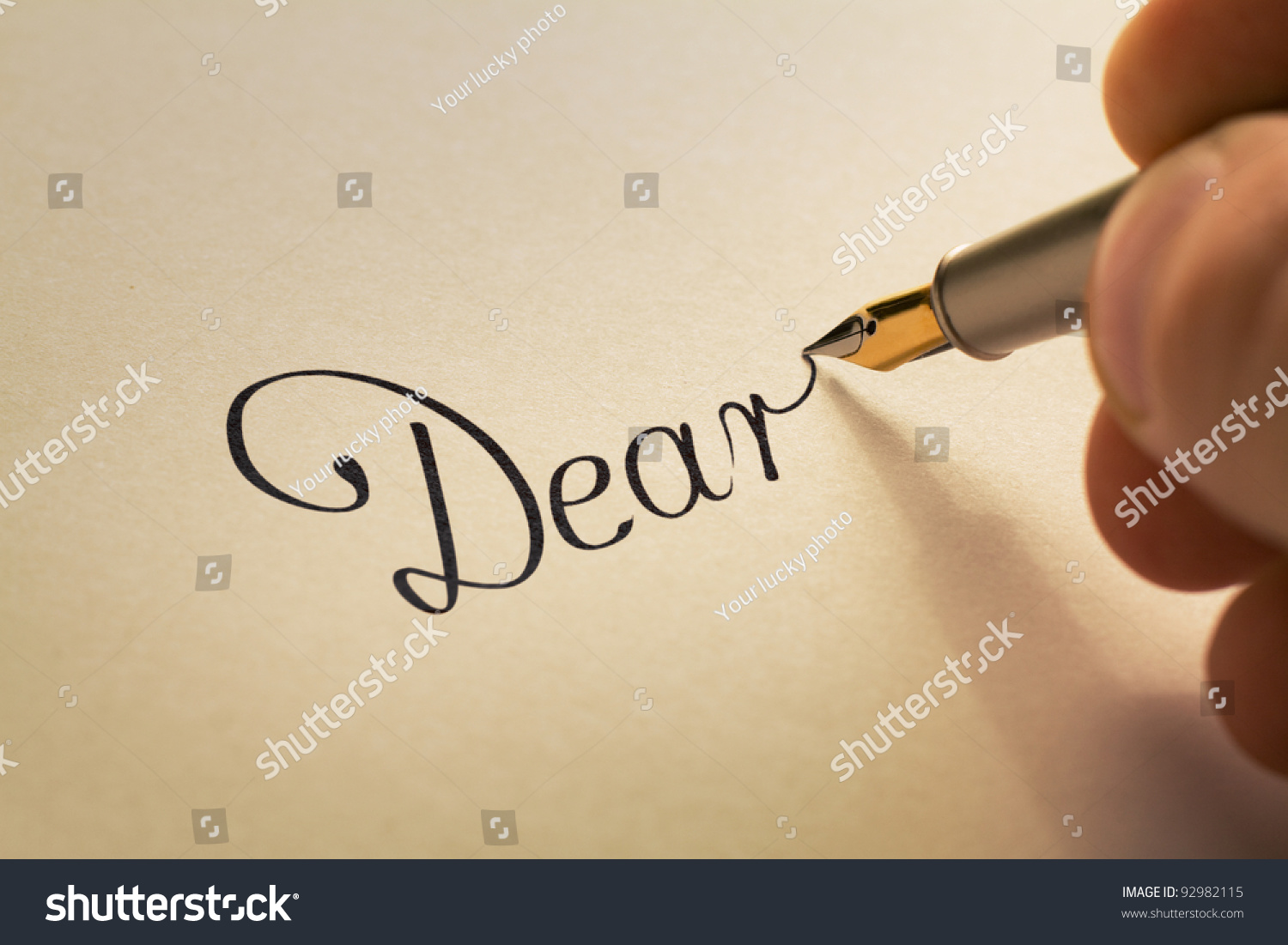 hand-is-writing-calligraphic-letter-starting-with-dear-using-old-pen-on