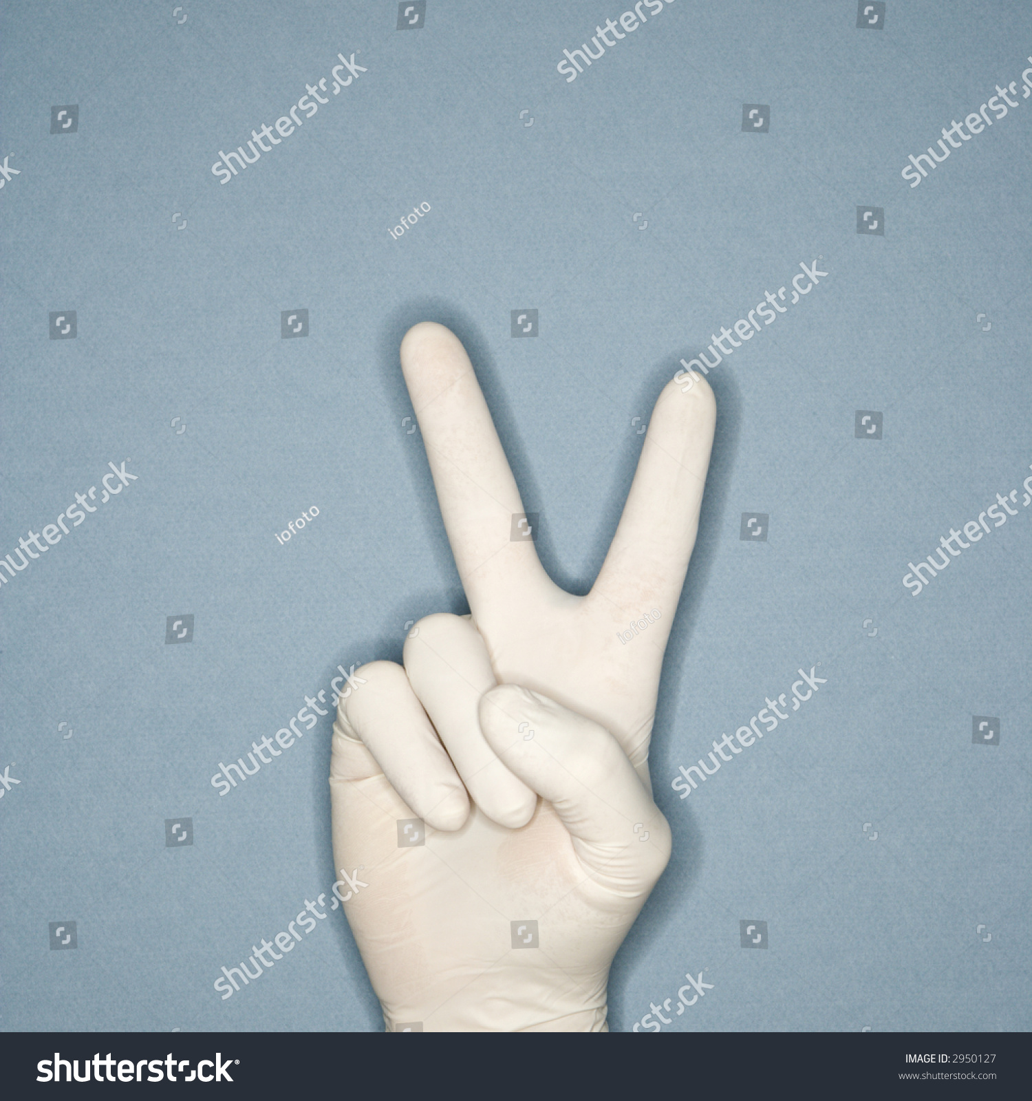 hand-wearing-white-rubber-glove-making-a-gesture-meaning-peace-stock