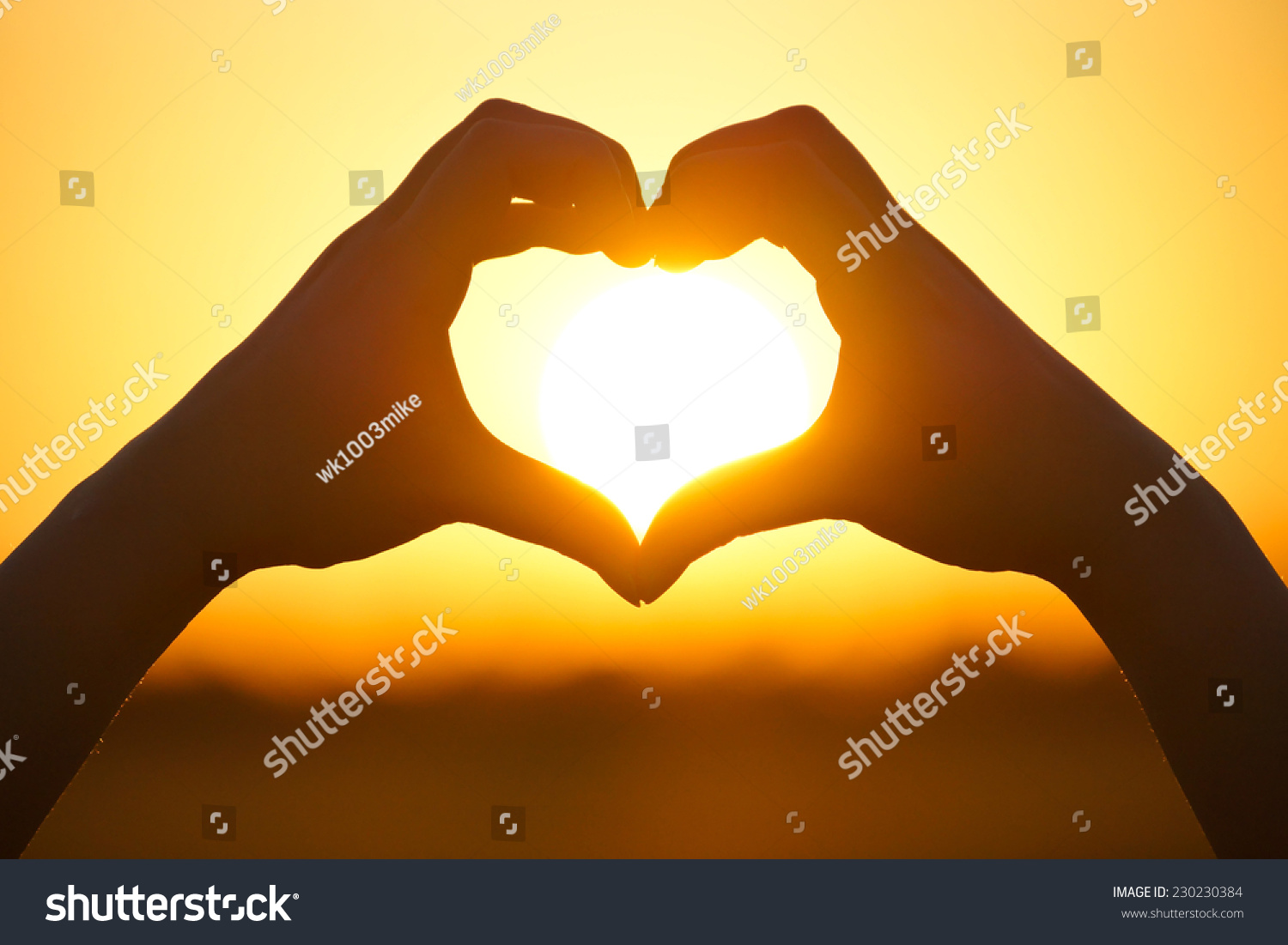Hands Forming A Heart Shape With Sunset Silhouette Stock Photo 
