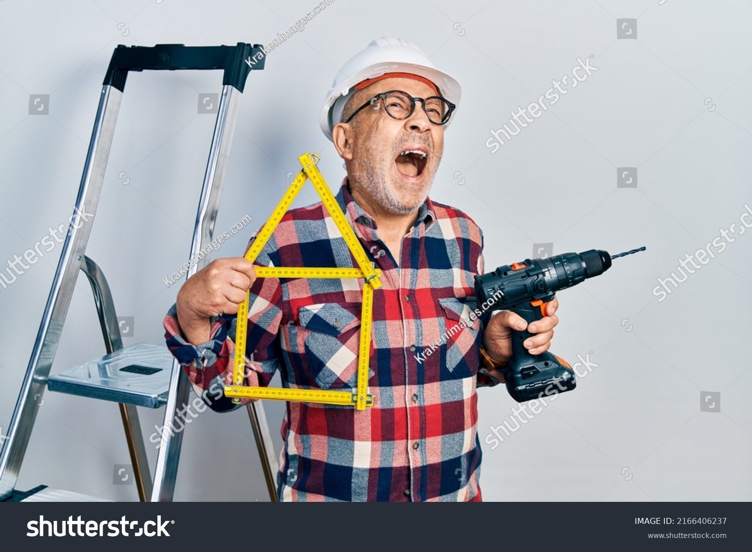 Handsome Mature Handyman Holding Screwdriver Wearing Stock Photo