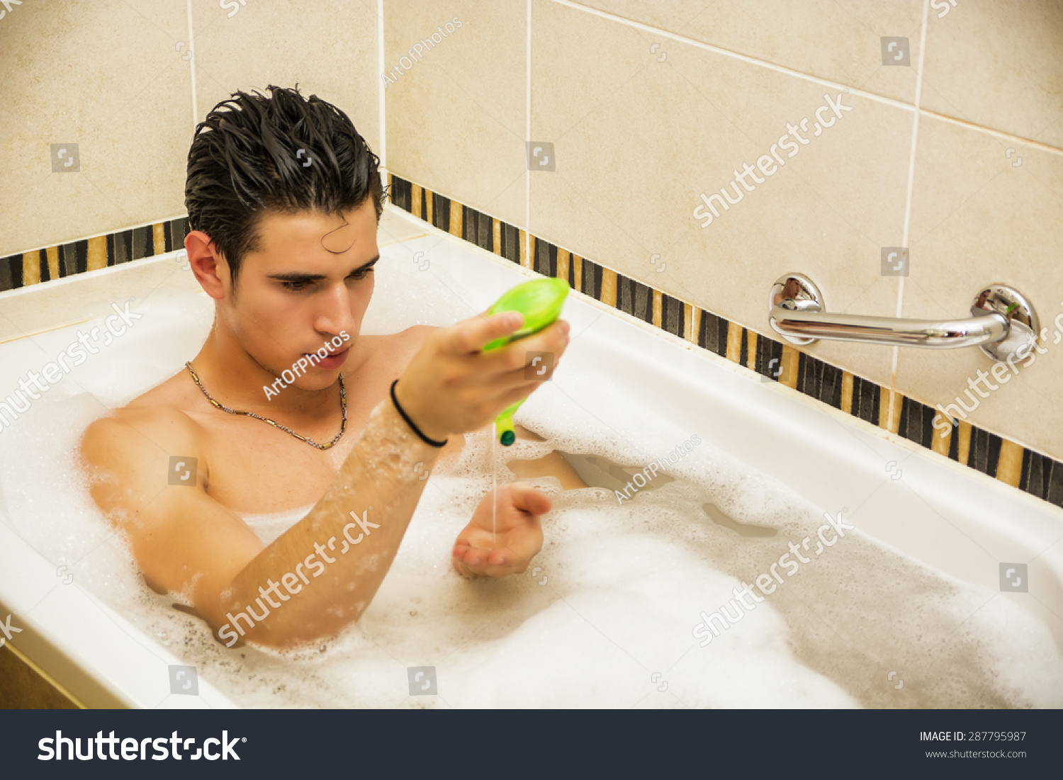 Handsome Young Man In Bathtub At Home Having Bath