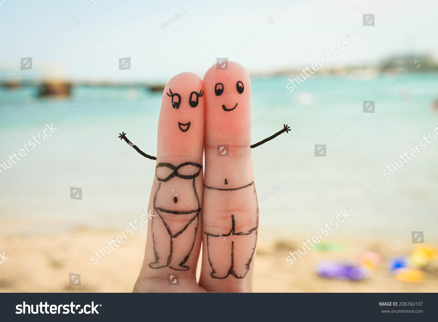 Happy Couple Man And Woman Have A Rest On The Beach In Bathing Suits