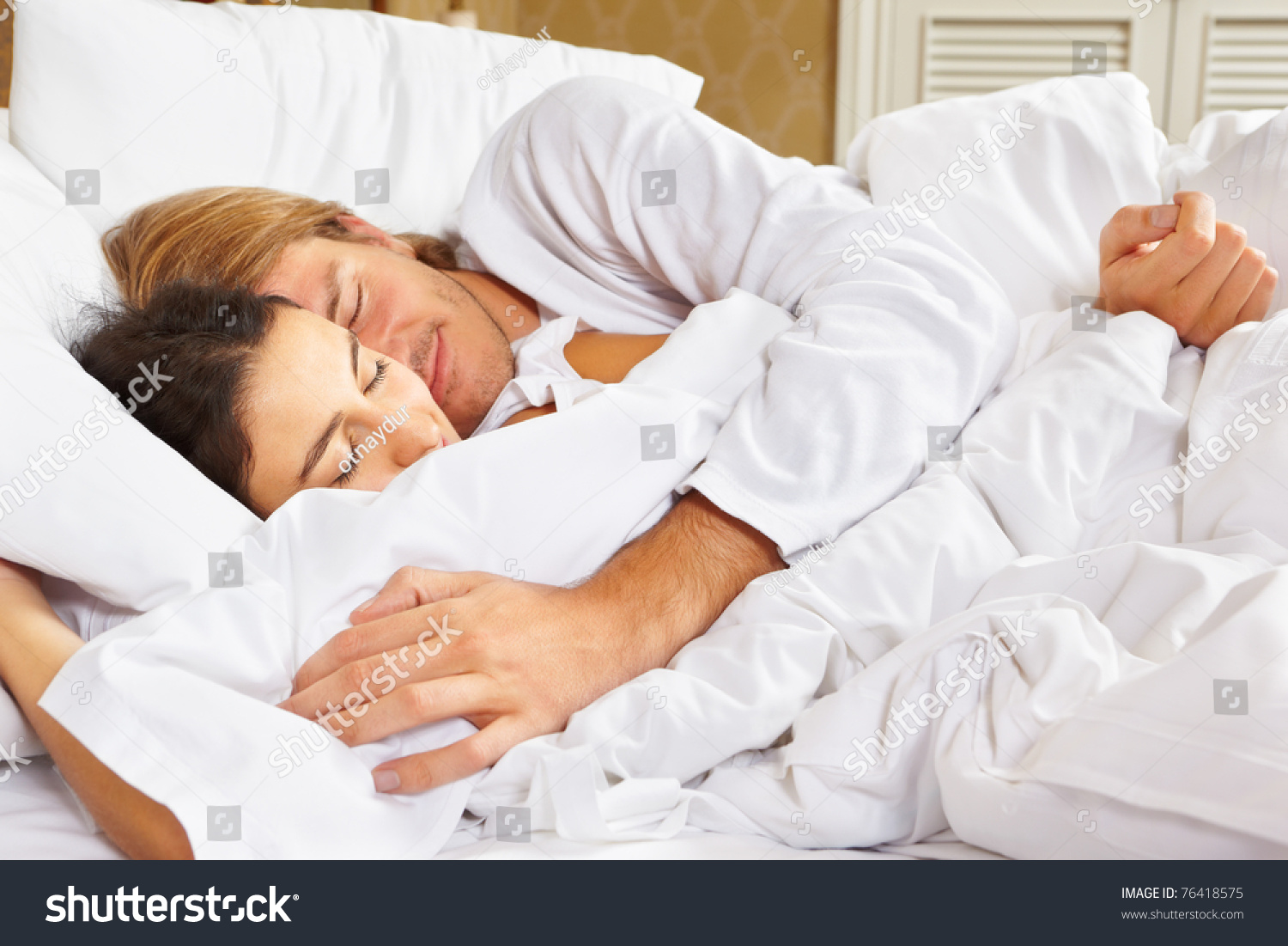 Happy Couple Showing Their Romance On Fully Covered White Bed Stock