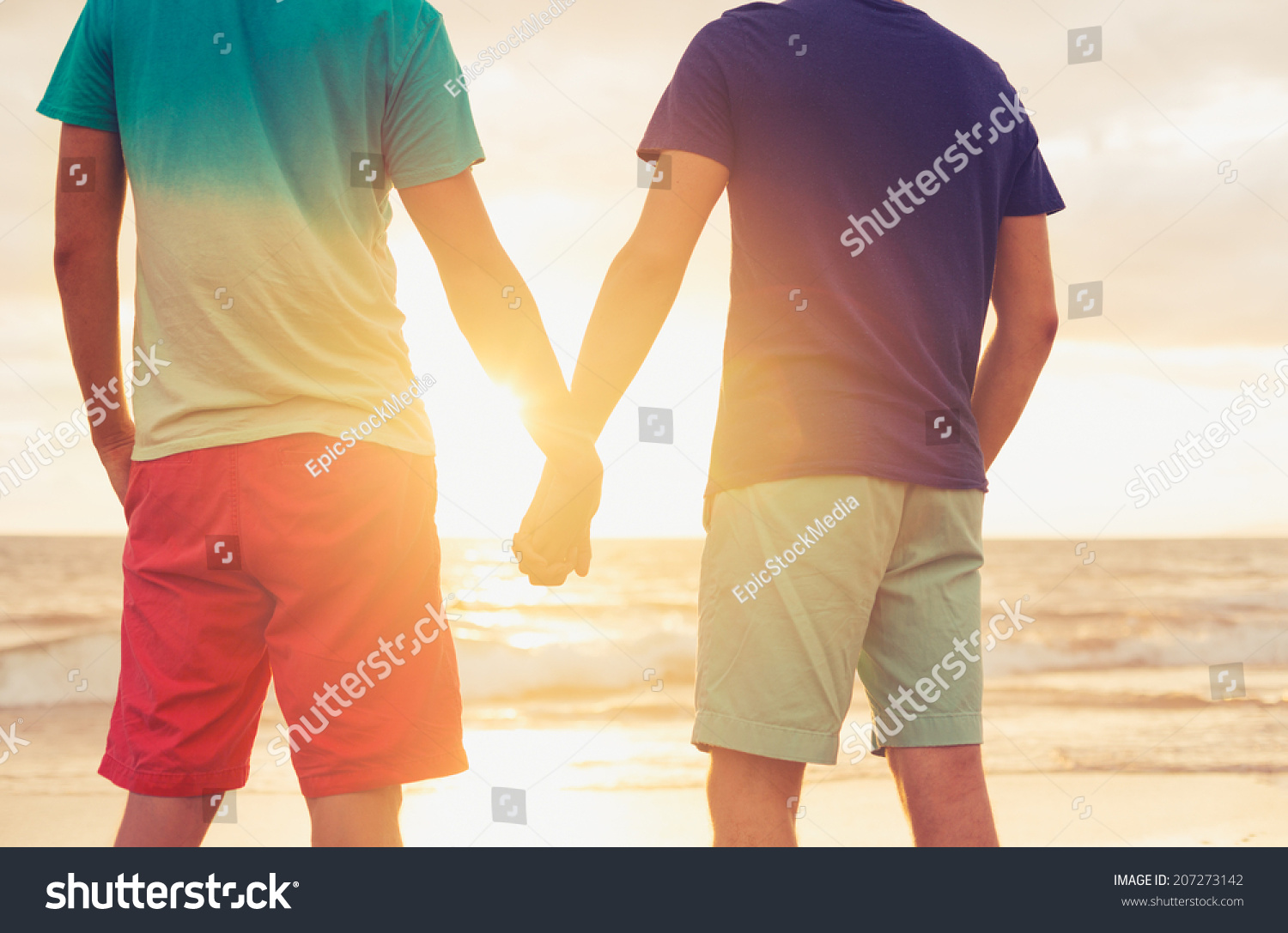 Outdise Holding Hands Gay couple watching sunset Outdise Holding Hands Gay couple watching sunset