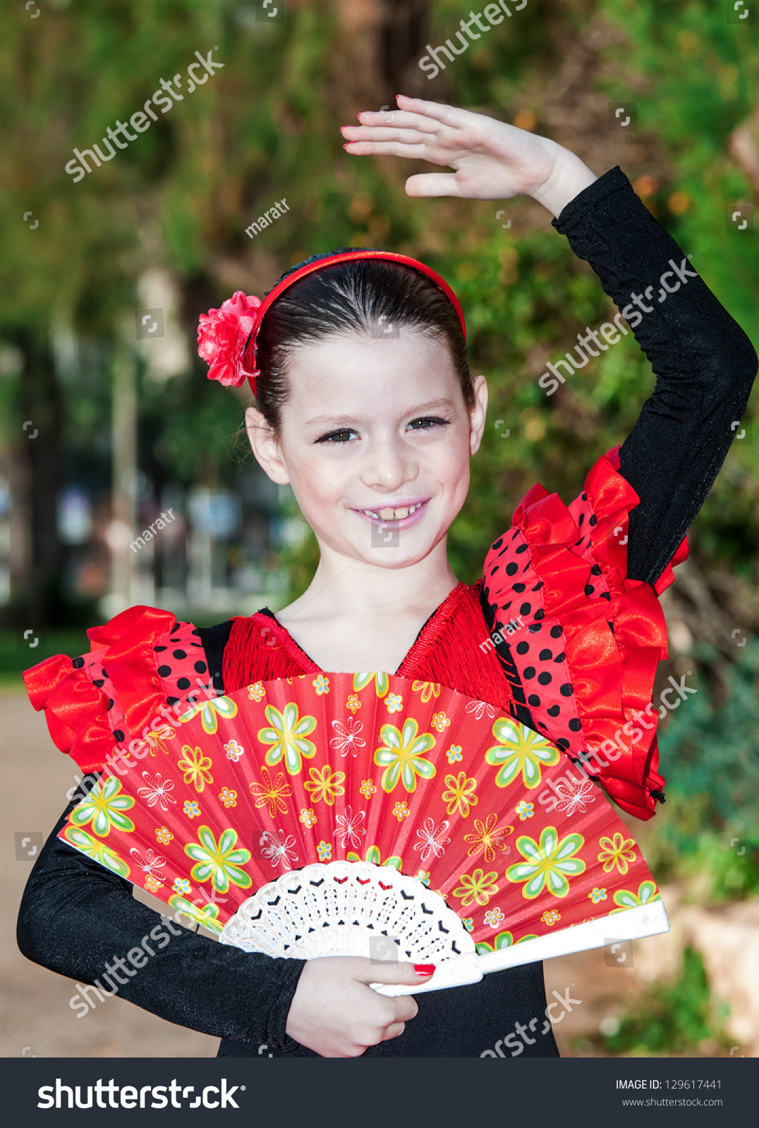 happy-little-pretty-girl-in-spanish-red-dress-stock-photo-129617441