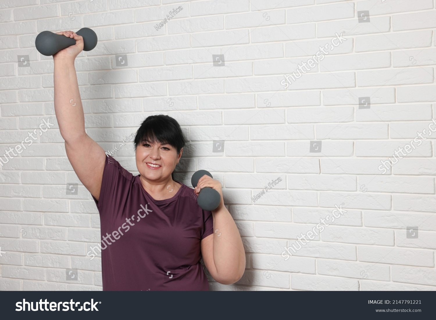 Happy Overweight Mature Woman Doing Exercise Stock Photo 2147791221