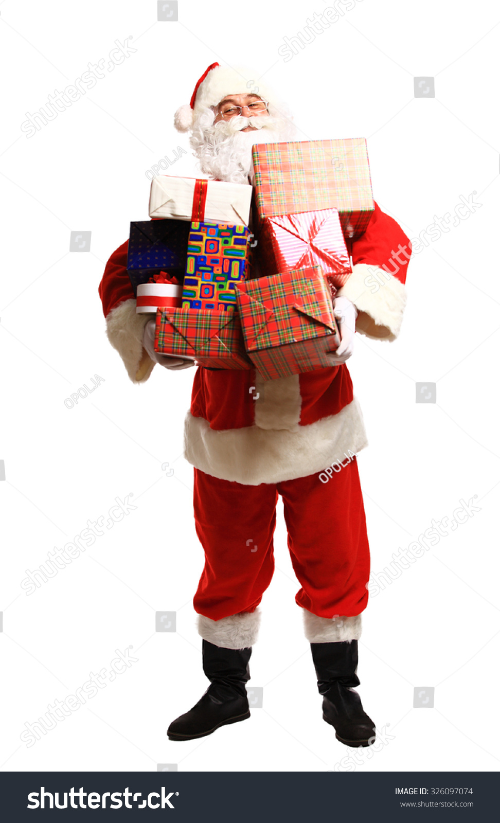 Happy Santa Claus with xmas presents looking at camera Happy Santa Claus with xmas presents looking at camera