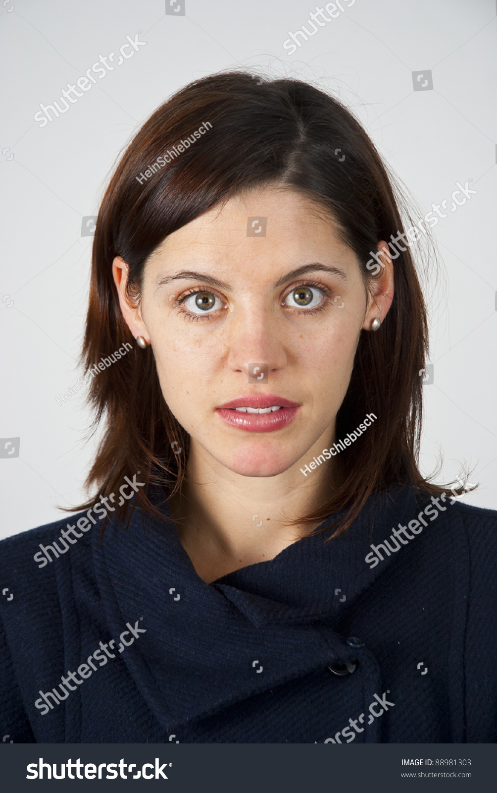 Head And Shoulders Shot Of A Young Caucasian Woman Looking Straight At