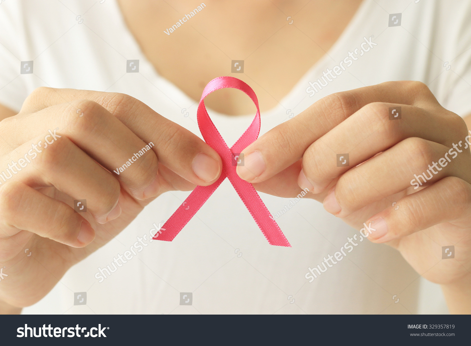 healthcare and medicine concept Woman hand holding pink breast cancer awareness ribbon healthcare and medicine concept Woman hand holding pink breast cancer awareness ribbon