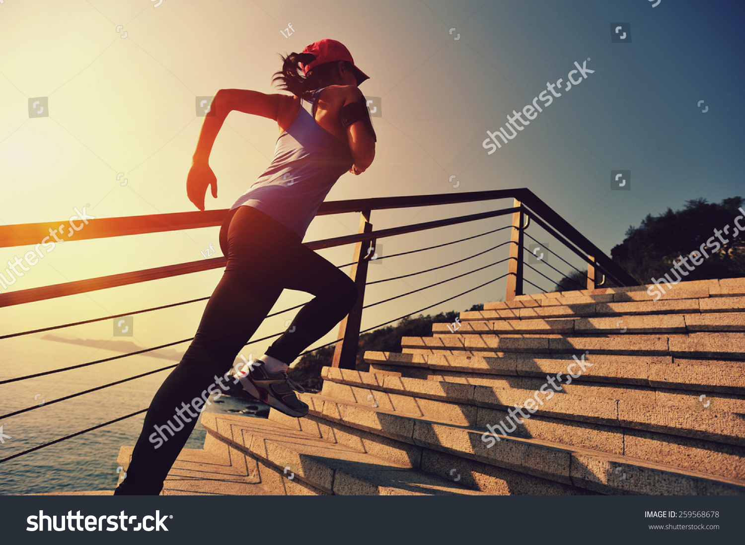 healthy lifestyle sports woman running up on stone stairs sunrise ...