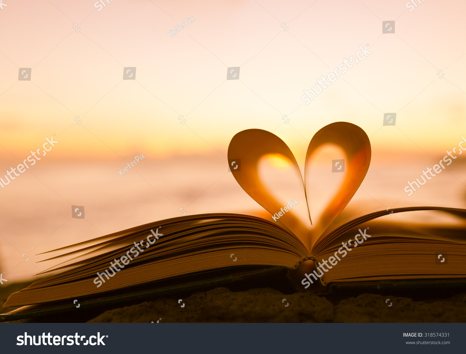 Heart from a book page against a beautiful sunset Heart from a book page against a beautiful sunset