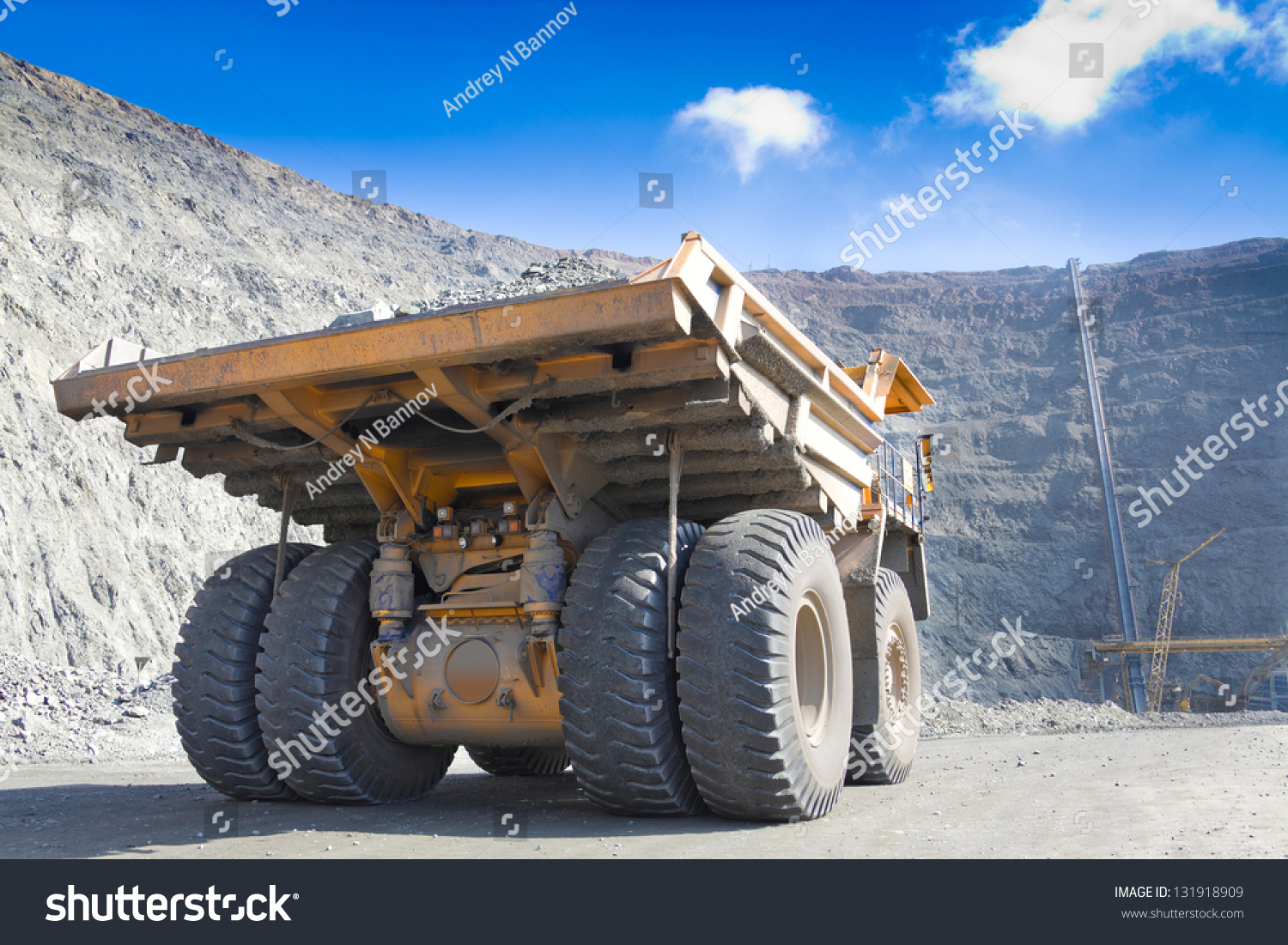 Heavy Mining Dump Truck Driving Along The Opencast Ore Conveyor At