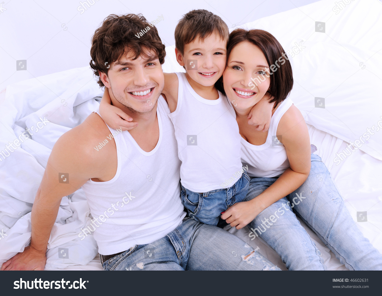 http://image.shutterstock.com/z/stock-photo-high-angle-portrait-of-the-happy-parents-with-little-child-sitting-on-a-bed-46602631.jpg