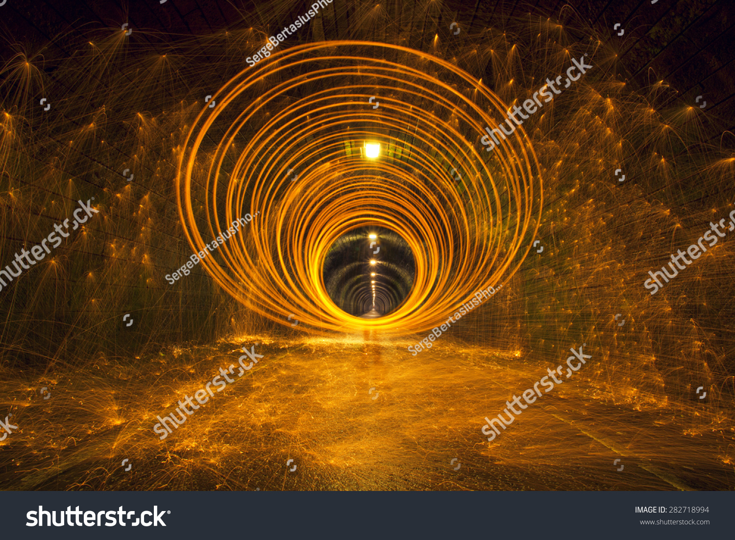 Hot golden sparks Flying off spinning Burning Steel Wool in undergound tunnel Hot golden sparks Flying off spinning Burning Steel Wool in undergound tunnel