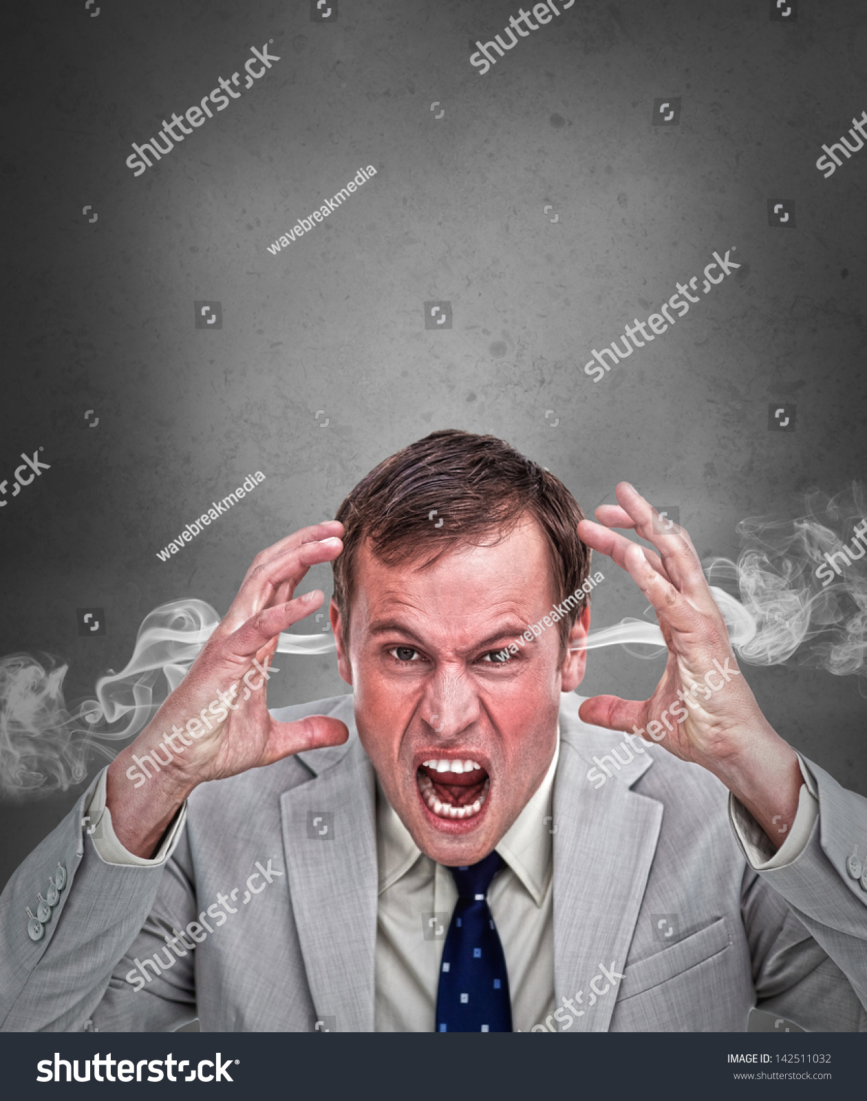 hot-headed-business-man-shouting-on-grey-background-with-copy-space