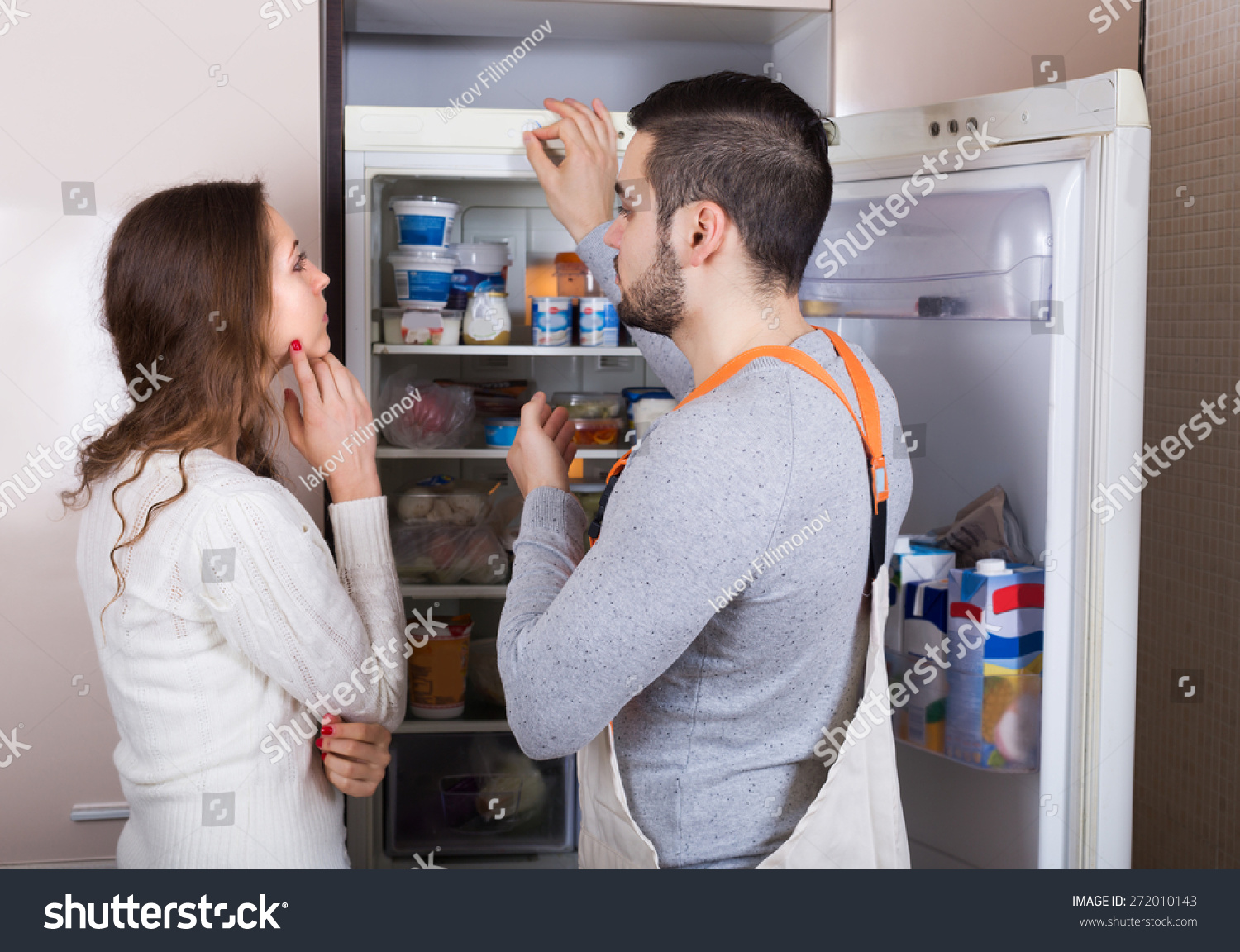 Housewife Showing Broken Refrigerator To Serious Repairman Stock Ph