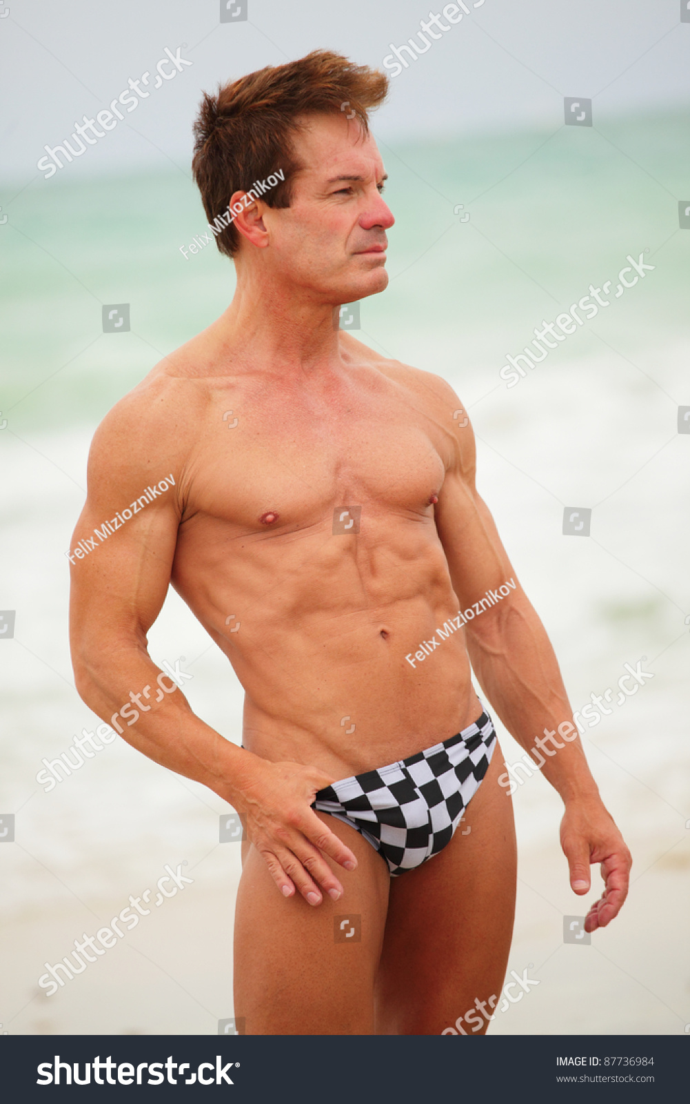 Image Of A Muscular Man Posing On The Beach Stock Photo 87736984