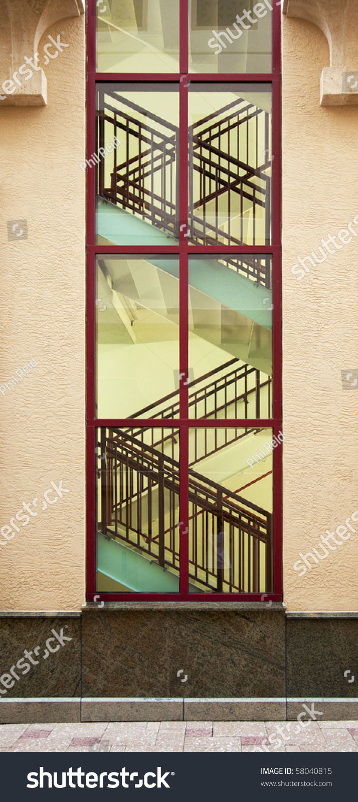 Interior Stairs As Seen Through Large Window From Outside. Stock Photo