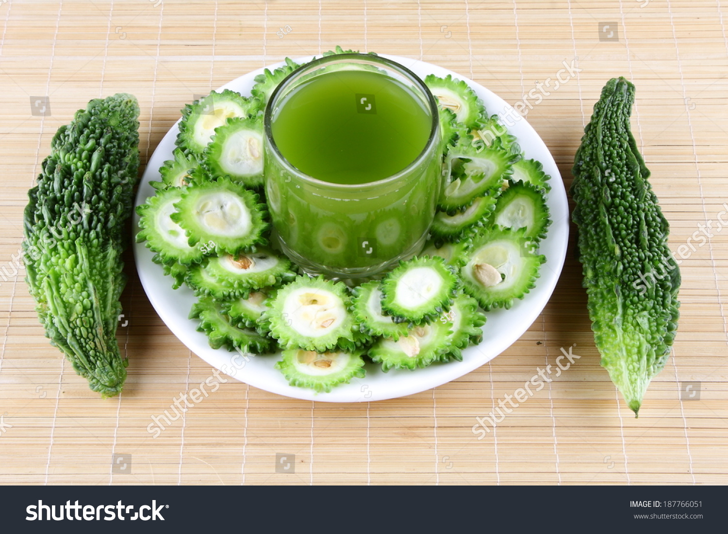 Juice Of Bitter Gourd With Raw And Sliced Bitter Gourd. Stock Photo