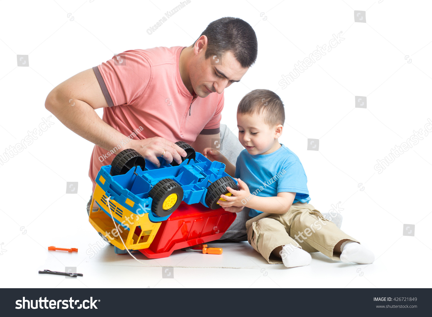 kid boy and his daddy fixing toy trunk kid boy and his daddy fixing toy trunk