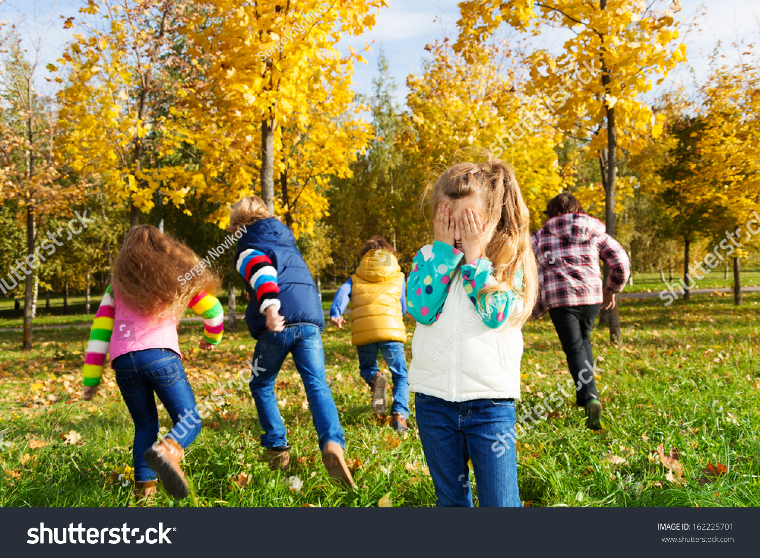 Kids Playing Hide And Seek In Autumn Park Stock Photo 162225701