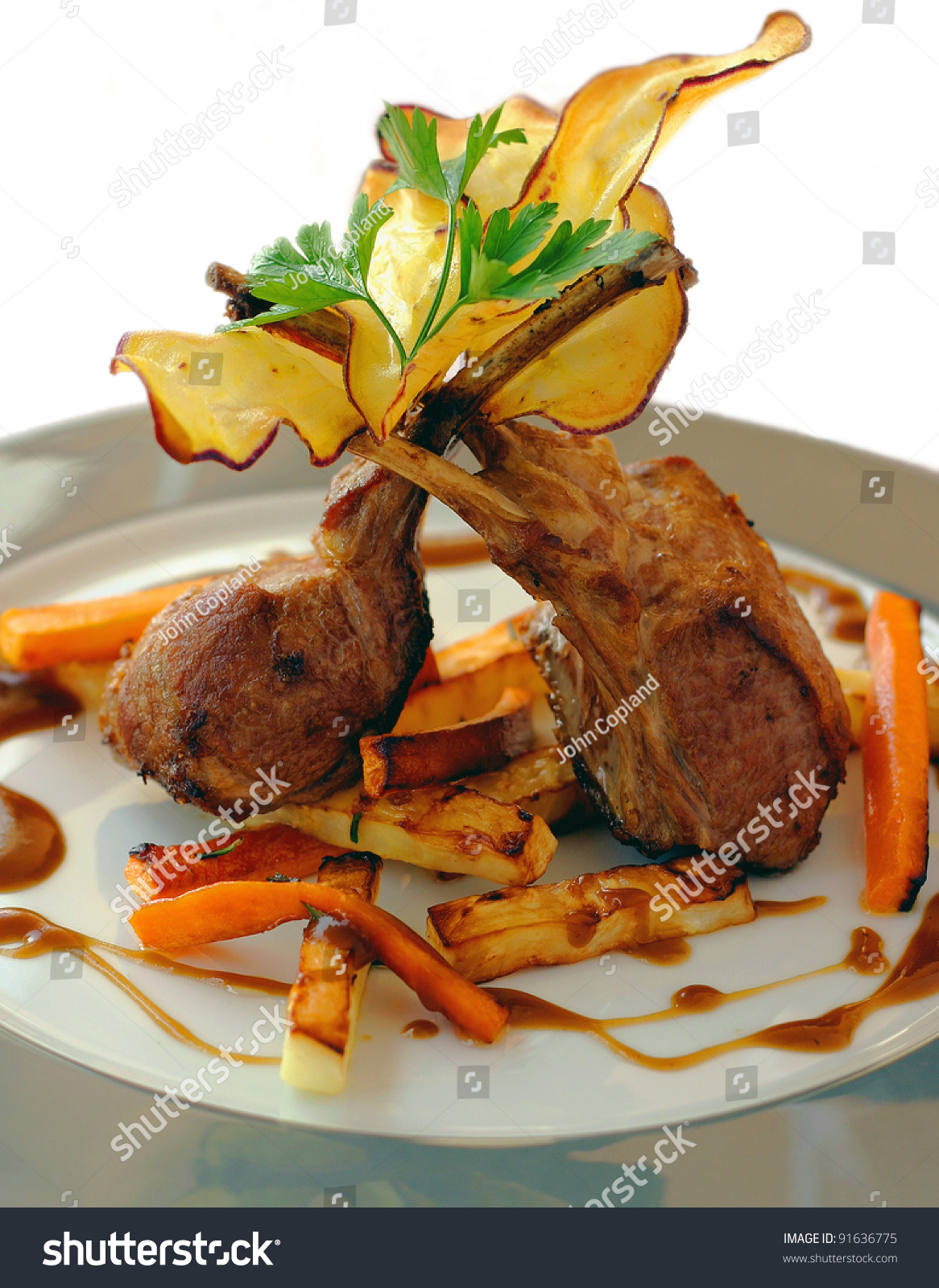 Lamb Chops With Portuguese Sweet Potato Chips And Glazed Carrots On ...