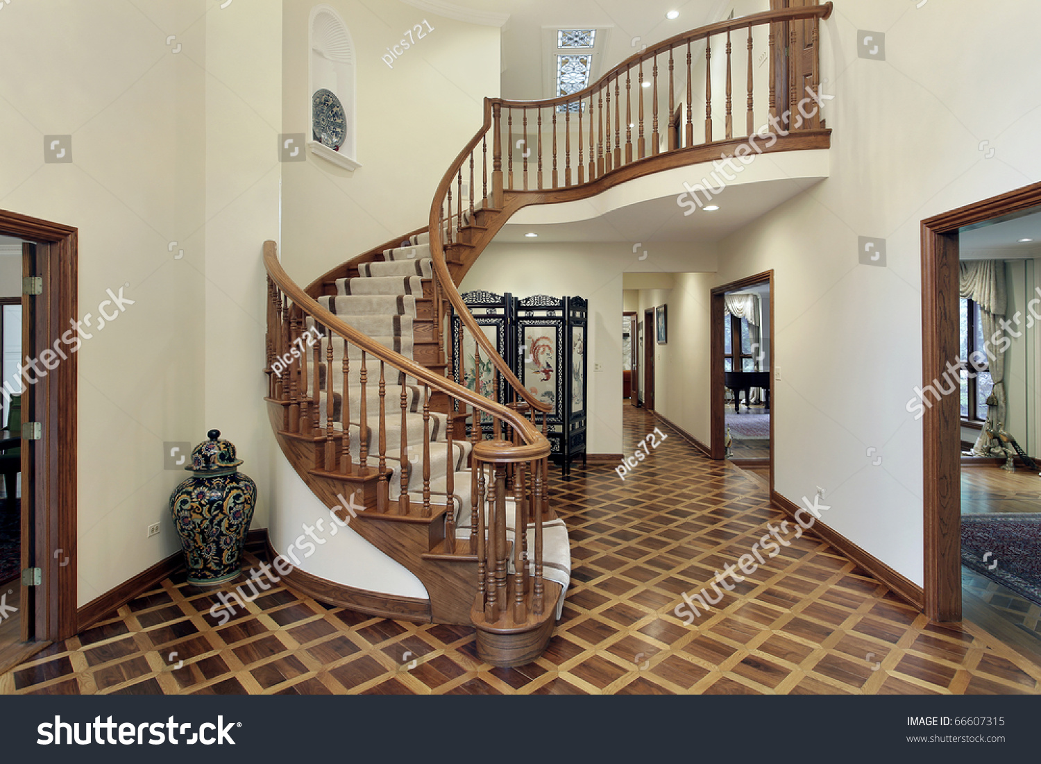 Large foyer in luxury home with circular staircase stock photo ...