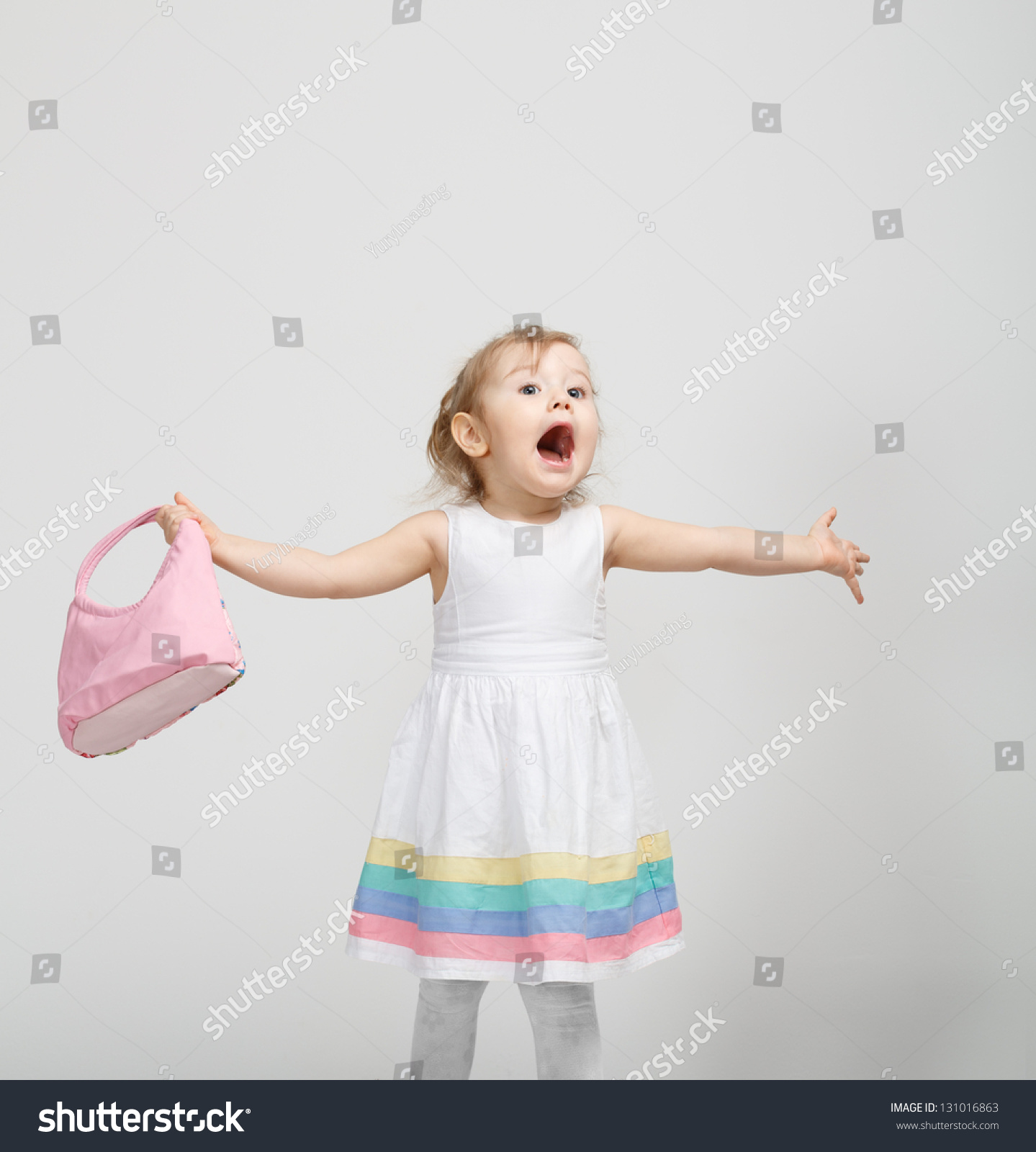 Portrait Of Happy Little Girl Sitting On Bed With Legs Crossed Kid