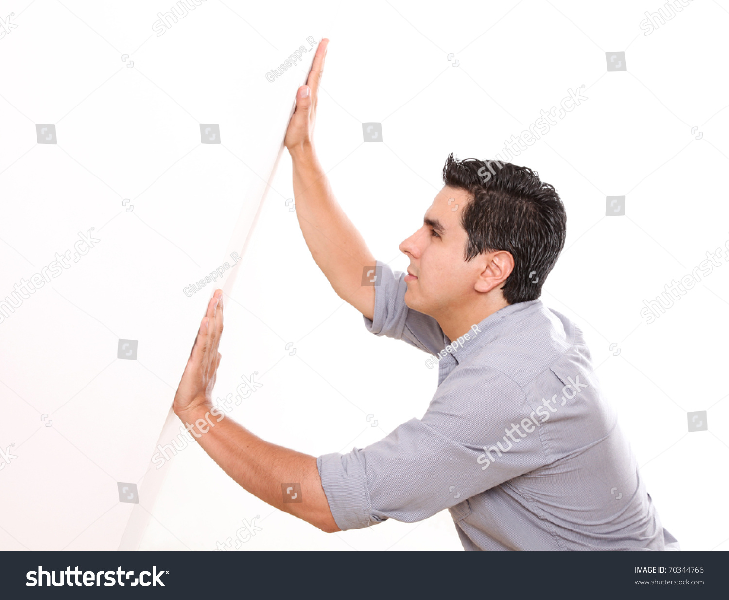 Man Holding A White Wall Over White Background Stock Photo 70344766